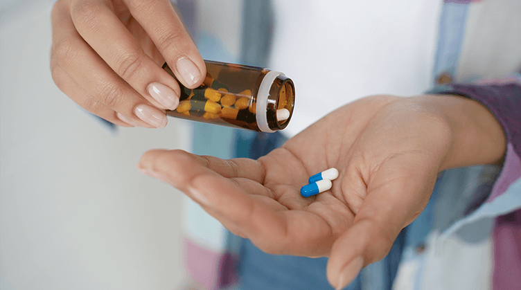 prescription medication in patient hand