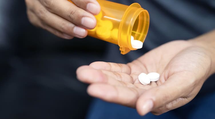 medication pill bottle and hand